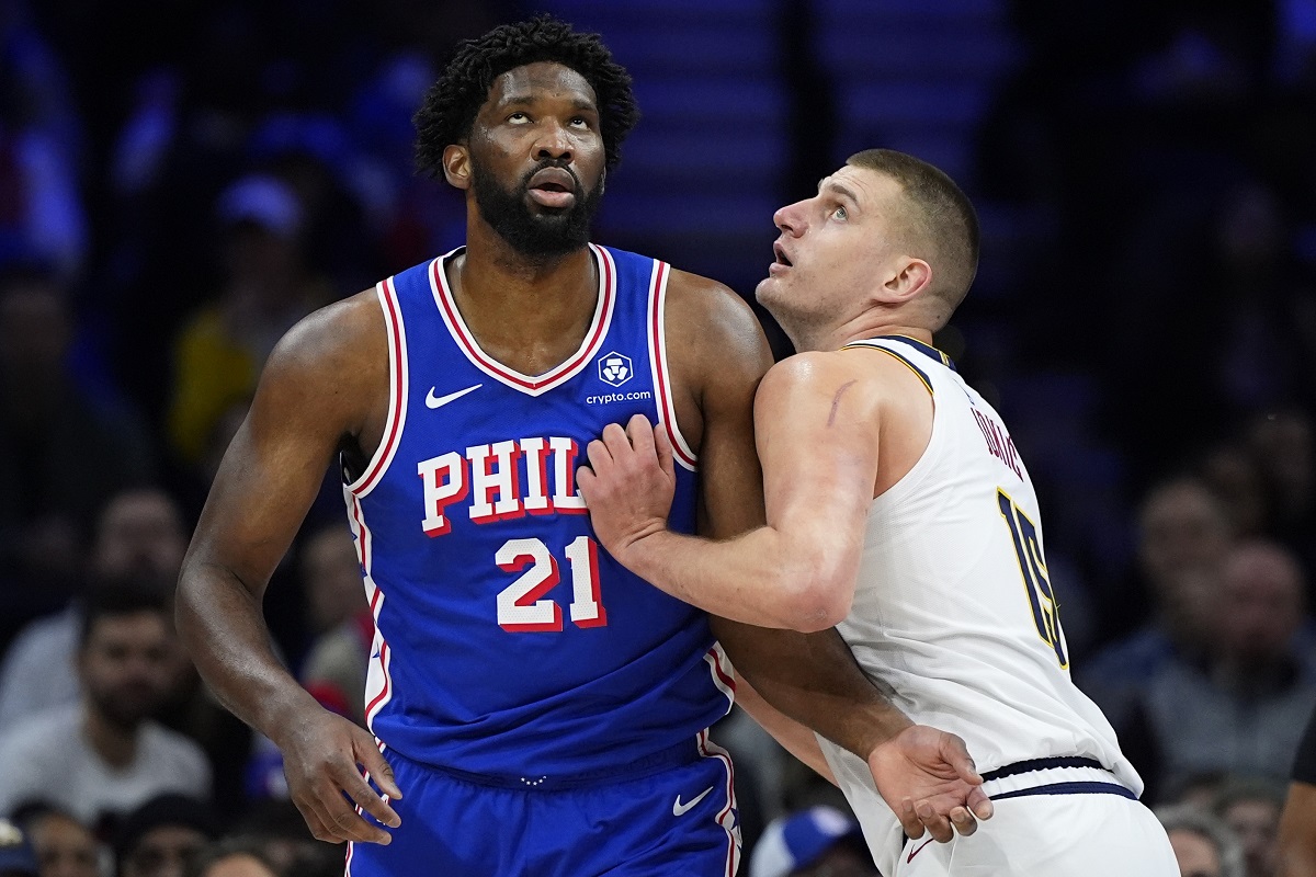 Philadelphia 76ers' Joel Embiid, elft, and Denver Nuggets' Nikola Jokic struggle for position during the first half of an NBA basketball game, Tuesday, Jan. 16, 2024, in Philadelphia. (AP Photo/Matt Slocum)