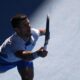 Novak Djokovic of Serbia plays a forehand return to Taylor Fritz of the U.S. during their quarterfinal match at the Australian Open tennis championships at Melbourne Park, Melbourne, Australia, Tuesday, Jan. 23, 2024. (AP Photo/Louise Delmotte)