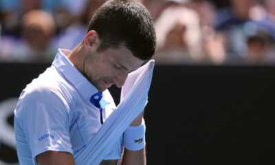 Novak Djokovic of Serbia wipes the sweat from his face during his semifinal against Jannik Sinner of Italy at the Australian Open tennis championships at Melbourne Park, Melbourne, Australia, Friday, Jan. 26, 2024. (AP Photo/Andy Wong)