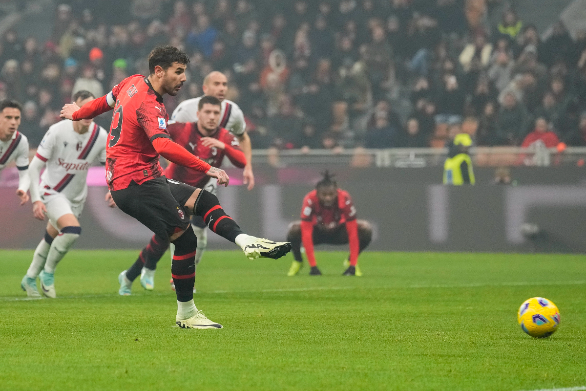 AC Milan's Theo Hernandez, front, fails to score from the penalty spot during the Serie A soccer match between AC Milan and Bologna at the San Siro stadium, in Milan, Italy, Saturday, Jan. 27, 2024. (AP Photo/Antonio Calanni)