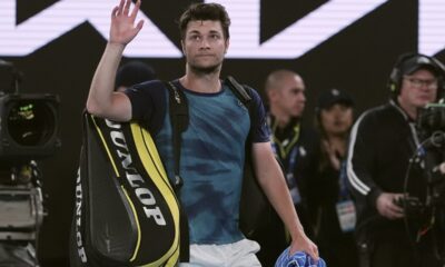Miomir Kecmanovic of Serbia waves as he leaves Rod Laver Arena following his fourth round loss to Carlos Alcaraz of Spain during their fourth round match at the Australian Open tennis championships at Melbourne Park, Melbourne, Australia, Monday, Jan. 22, 2024. (AP Photo/Andy Wong)