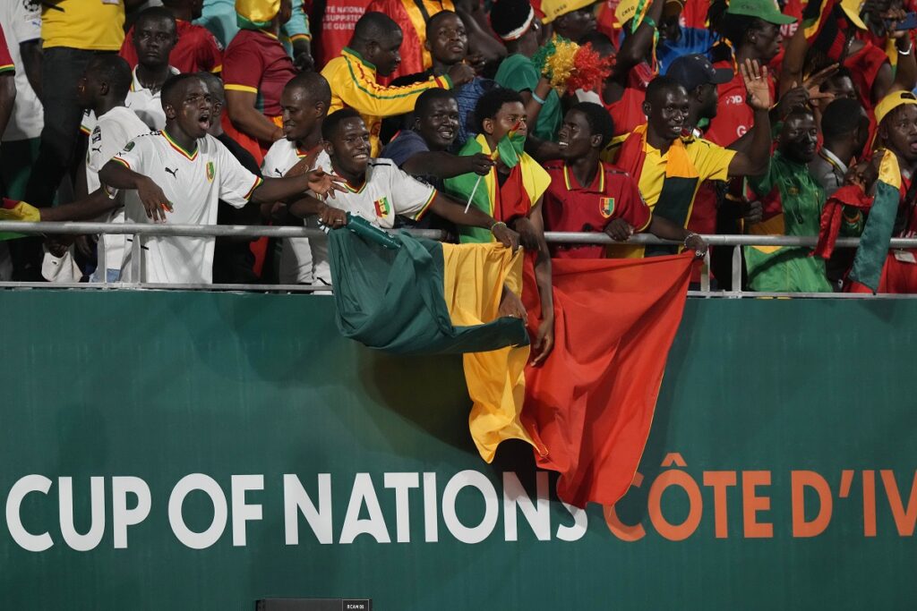 Guinea's supporters chant during the African Cup of Nations Group C soccer match between Cameroon and Guinea at the Charles Konan Banny stadium in Yamoussoukro, Ivory Coast, Monday, Jan. 15, 2024. (AP Photo/Sunday Alamba)
