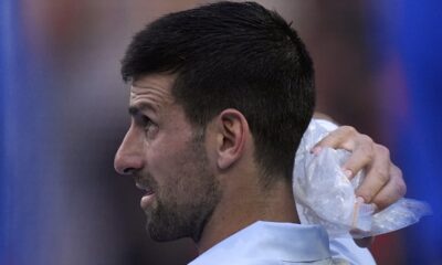 Novak Djokovic of Serbia places a bag of ice on his head during a break in his quarterfinal against Taylor Fritz of the U.S. at the Australian Open tennis championships at Melbourne Park, Melbourne, Australia, Tuesday, Jan. 23, 2024. (AP Photo/Andy Wong)
