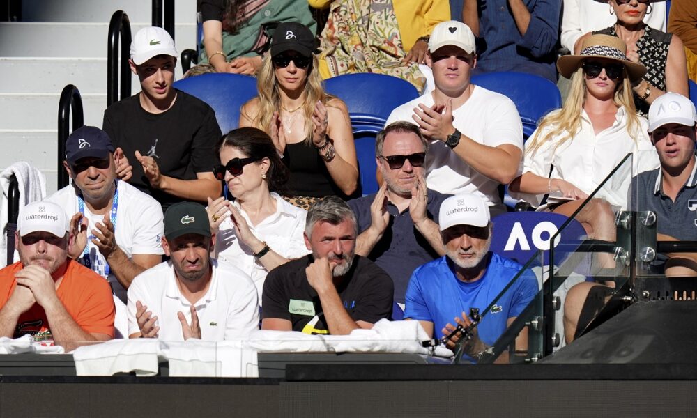 The support team for Novak Djokovic of Serbia watch his quarterfinal against Taylor Fritz of the U.S. at the Australian Open tennis championships at Melbourne Park, Melbourne, Australia, Tuesday, Jan. 23, 2024. (AP Photo/Andy Wong)