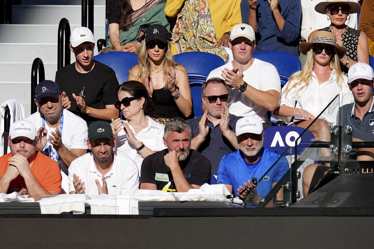 The support team for Novak Djokovic of Serbia watch his quarterfinal against Taylor Fritz of the U.S. at the Australian Open tennis championships at Melbourne Park, Melbourne, Australia, Tuesday, Jan. 23, 2024. (AP Photo/Andy Wong)