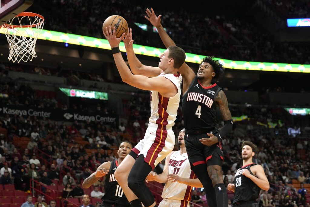 Miami Heat forward Nikola Jovic (5) drives to the basket as Houston Rockets guard Jalen Green (4) defends during the first half of an NBA basketball game, Monday, Jan. 8, 2024, in Miami. (AP Photo/Marta Lavandier)