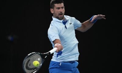 Novak Djokovic of Serbia plays a forehand return to Alexei Popyrin of Australia during their second round match at the Australian Open tennis championships at Melbourne Park, Melbourne, Australia, Wednesday, Jan. 17, 2024. (AP Photo/Louise Delmotte)