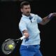 Novak Djokovic of Serbia plays a forehand return to Alexei Popyrin of Australia during their second round match at the Australian Open tennis championships at Melbourne Park, Melbourne, Australia, Wednesday, Jan. 17, 2024. (AP Photo/Louise Delmotte)