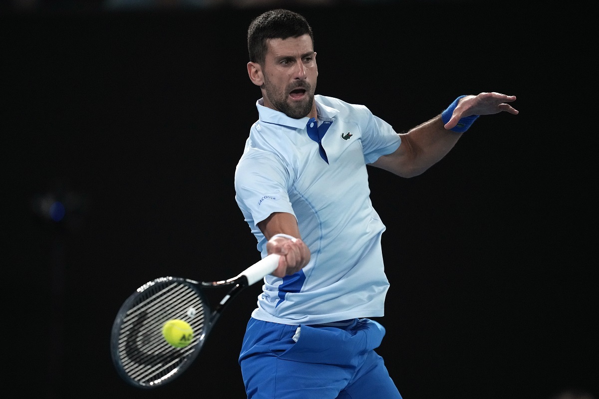 Novak Djokovic of Serbia plays a forehand return to Alexei Popyrin of Australia during their second round match at the Australian Open tennis championships at Melbourne Park, Melbourne, Australia, Wednesday, Jan. 17, 2024. (AP Photo/Louise Delmotte)