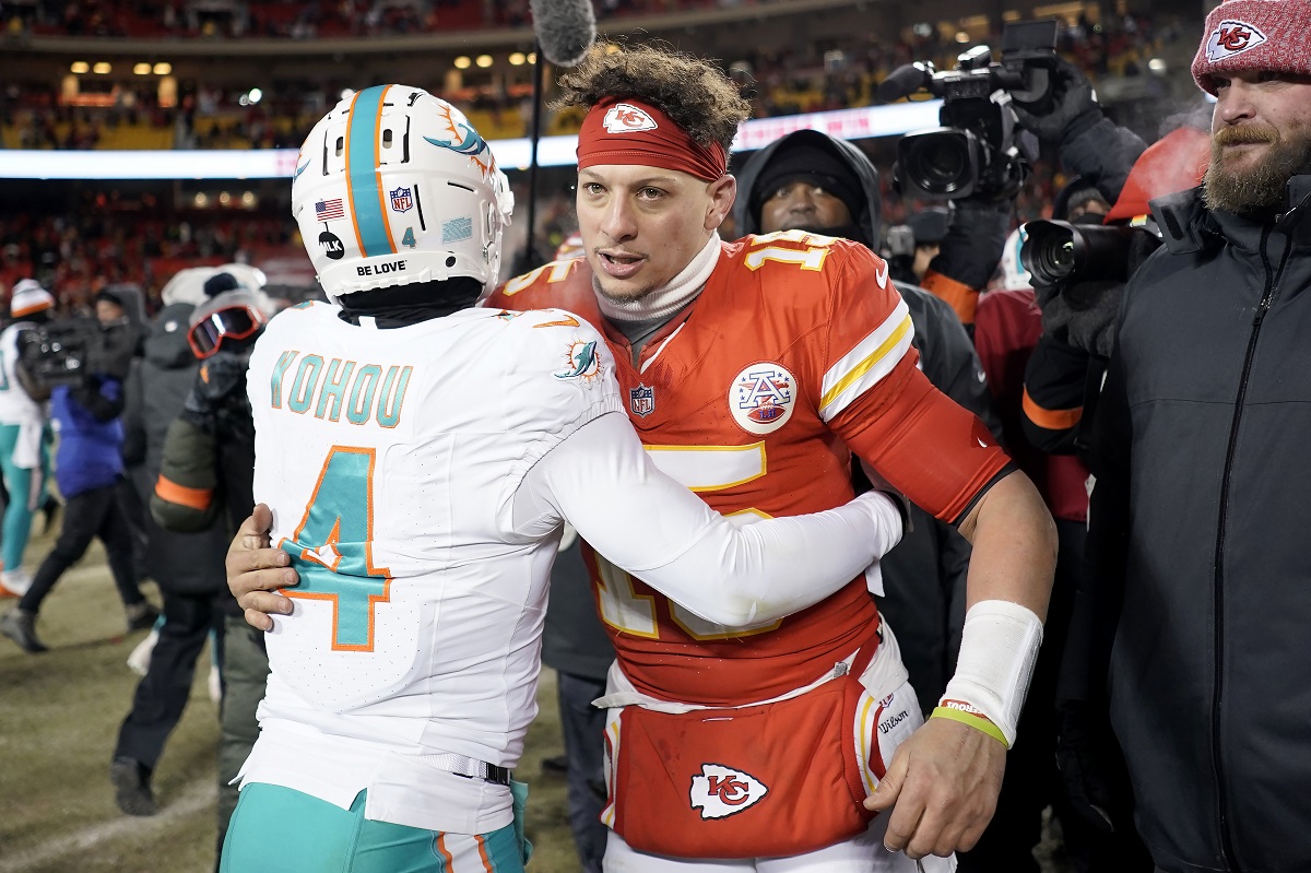 Miami Dolphins cornerback Kader Kohou (4) hugs Kansas City Chiefs quarterback Patrick Mahomes after an NFL wild-card playoff football game Saturday, Jan. 13, 2024, in Kansas City, Mo. (AP Photo/Charlie Riedel)