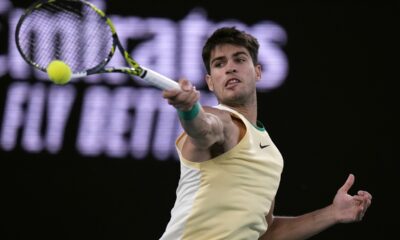 Carlos Alcaraz of Spain plays a forehand return to Miomir Kecmanovic of Serbia during their fourth round match at the Australian Open tennis championships at Melbourne Park, Melbourne, Australia, Monday, Jan. 22, 2024. (AP Photo/Andy Wong)