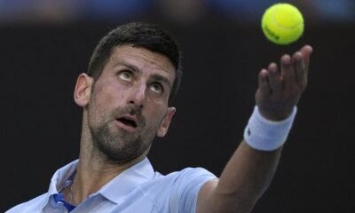 Novak Djokovic of Serbia serves to Taylor Fritz of the U.S. during their quarterfinal match at the Australian Open tennis championships at Melbourne Park, Melbourne, Australia, Tuesday, Jan. 23, 2024. (AP Photo/Louise Delmotte)