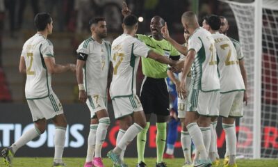 Algeria players protest to the referee Issa Sy during the African Cup of Nations Group D soccer match between Algeria and Angola in Bouake, Ivory Coast, Monday, Jan. 15, 2024. (AP Photo/Themba Hadebe)