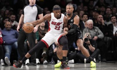 Miami Heat forward Jimmy Butler (22) drives against Brooklyn Nets guard Dennis Smith Jr., right, during the second half of an NBA basketball game, Monday, Jan. 15, 2024, in New York. (AP Photo/Mary Altaffer)