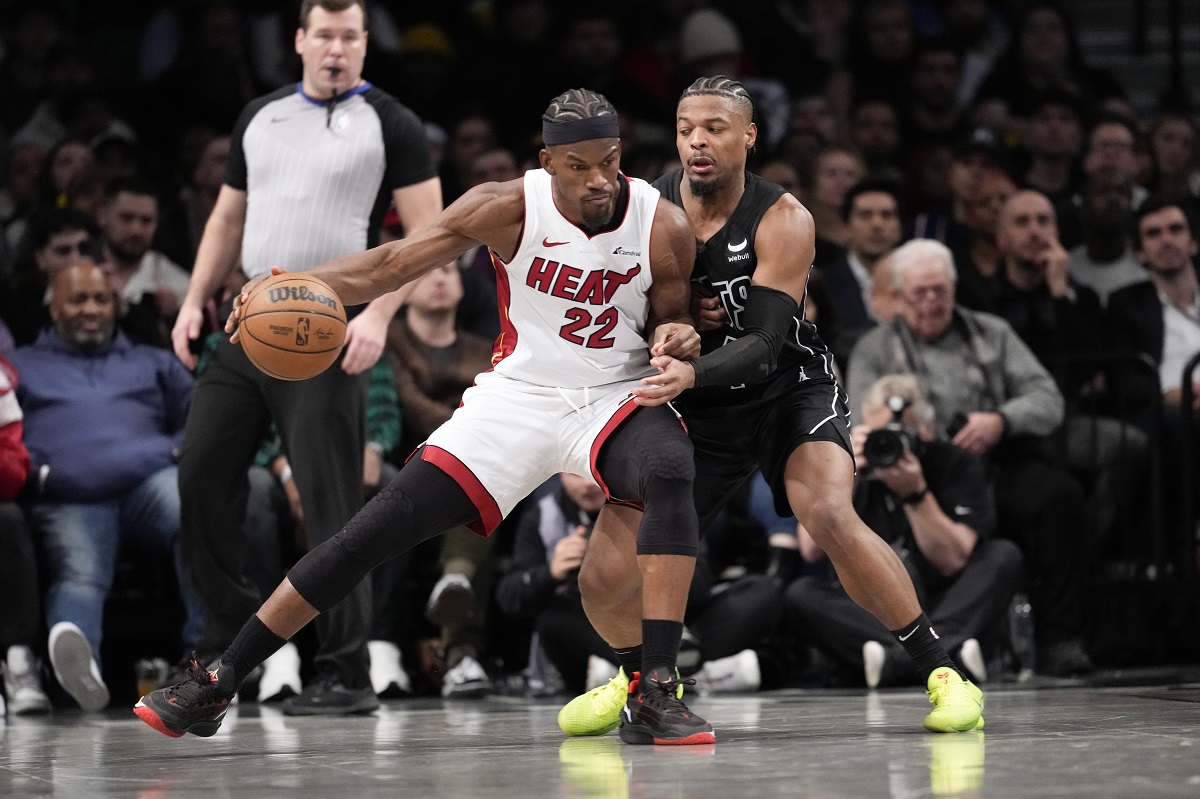 Miami Heat forward Jimmy Butler (22) drives against Brooklyn Nets guard Dennis Smith Jr., right, during the second half of an NBA basketball game, Monday, Jan. 15, 2024, in New York. (AP Photo/Mary Altaffer)