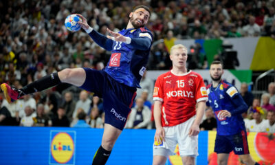 France's Ludovic Fabregas, left, throws the ball against Denmark's Magnus Saugstrup during the Handball European Championship final match between France and Denmark in Cologne, Germany, Sunday, Jan. 28, 2024. (AP Photo/Martin Meissner)