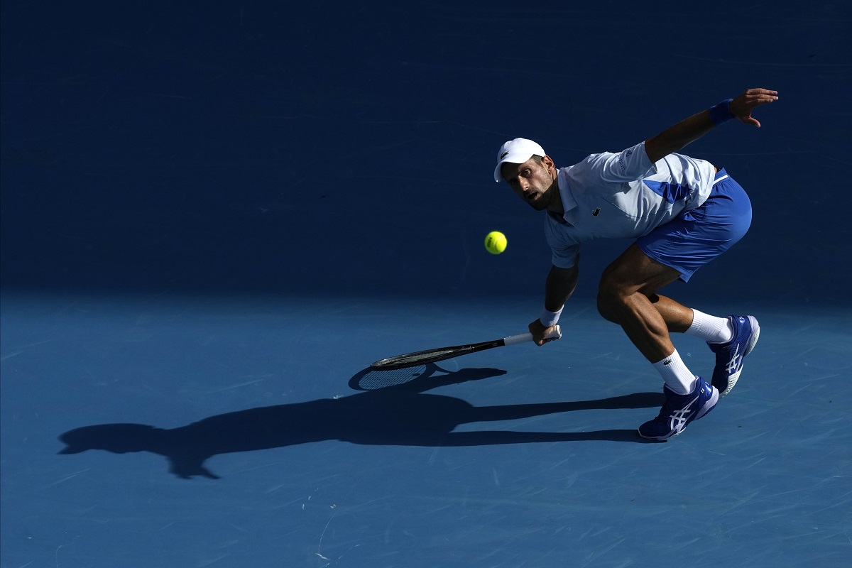 Novak Djokovic of Serbia plays a forehand return to Taylor Fritz of the U.S. during their quarterfinal match at the Australian Open tennis championships at Melbourne Park, Melbourne, Australia, Tuesday, Jan. 23, 2024. (AP Photo/Alessandra Tarantino)