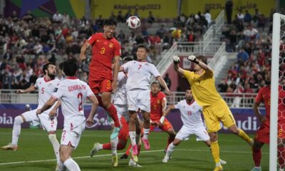 China's Zhu Chenjie (3) heads the ball in an attempt to score during the Asian Cup Group A soccer match between China and Tajikistan at Abdullah Bin Khalifa Stadium in Doha, Qatar, Saturday, Jan. 13, 2024. (AP Photo/Thanassis Stavrakis)