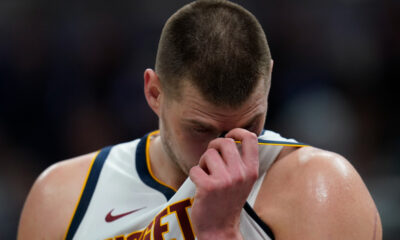 Denver Nuggets' Nikola Jokic wipes his face during the second half of an NBA basketball game against the Indiana Pacers, Tuesday, Jan. 23, 2024, in Indianapolis. (AP Photo/Darron Cummings)
