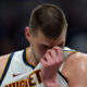 Denver Nuggets' Nikola Jokic wipes his face during the second half of an NBA basketball game against the Indiana Pacers, Tuesday, Jan. 23, 2024, in Indianapolis. (AP Photo/Darron Cummings)