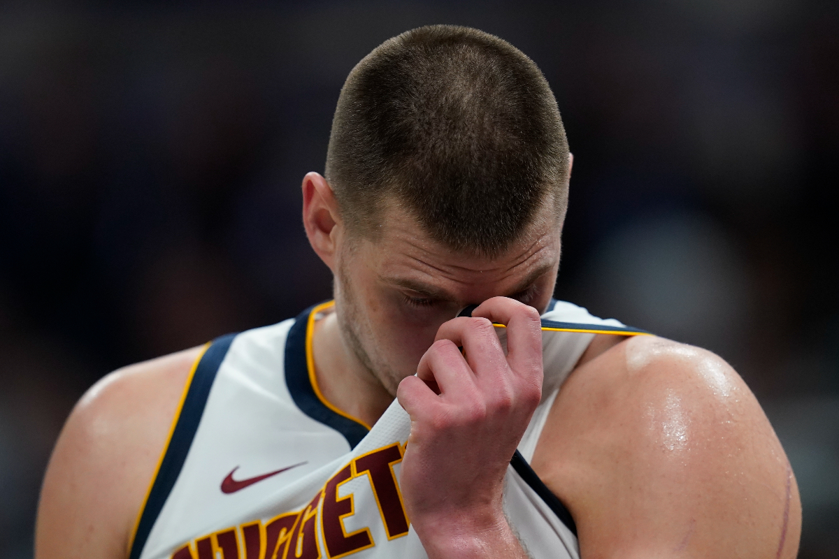 Denver Nuggets' Nikola Jokic wipes his face during the second half of an NBA basketball game against the Indiana Pacers, Tuesday, Jan. 23, 2024, in Indianapolis. (AP Photo/Darron Cummings)