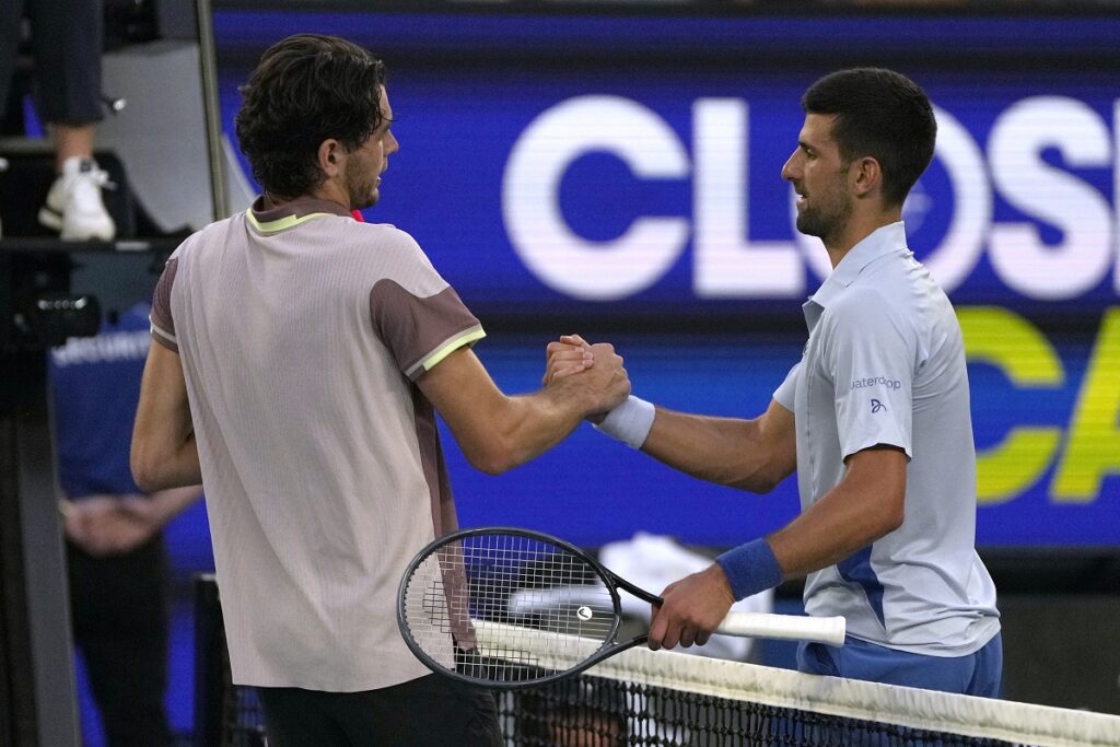 Novak Djokovic of Serbia, right, is congratulated by Taylor Fritz, left, of the U.S. following their quarterfinal match at the Australian Open tennis championships at Melbourne Park, Melbourne, Australia, Tuesday, Jan. 23, 2024. (AP Photo/Louise Delmotte)