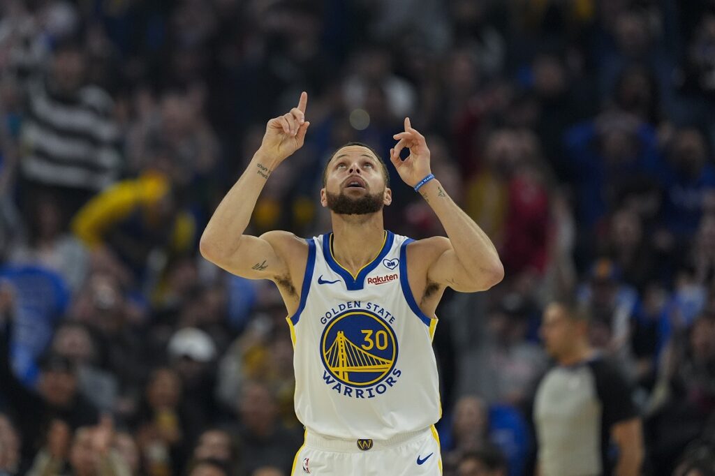 Golden State Warriors guard Stephen Curry reacts after scoring a 3-point basket against the Atlanta Hawks during the first half of an NBA basketball game, Wednesday, Jan. 24, 2024, in San Francisco. (AP Photo/Godofredo A. Vásquez)