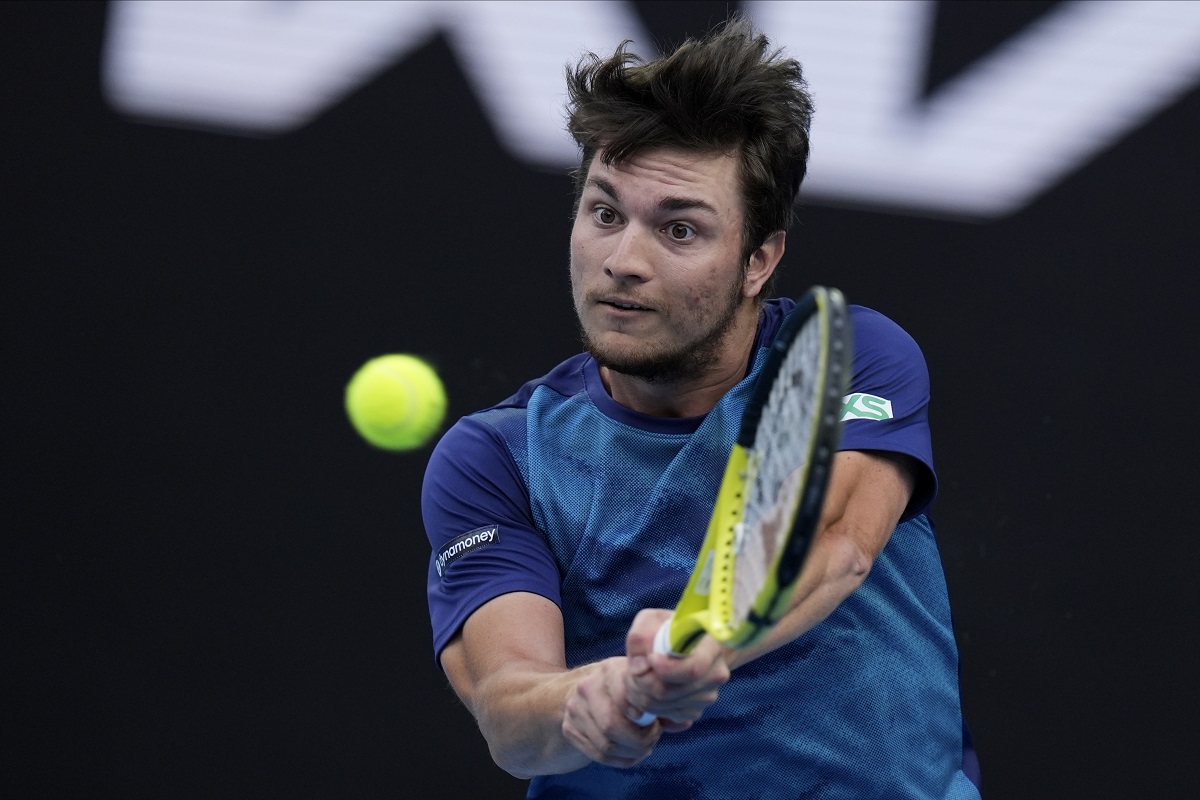 Miomir Kecmanovic of Serbia plays a backhand return to Carlos Alcaraz of Spain during their fourth round match at the Australian Open tennis championships at Melbourne Park, Melbourne, Australia, Monday, Jan. 22, 2024. (AP Photo/Andy Wong)