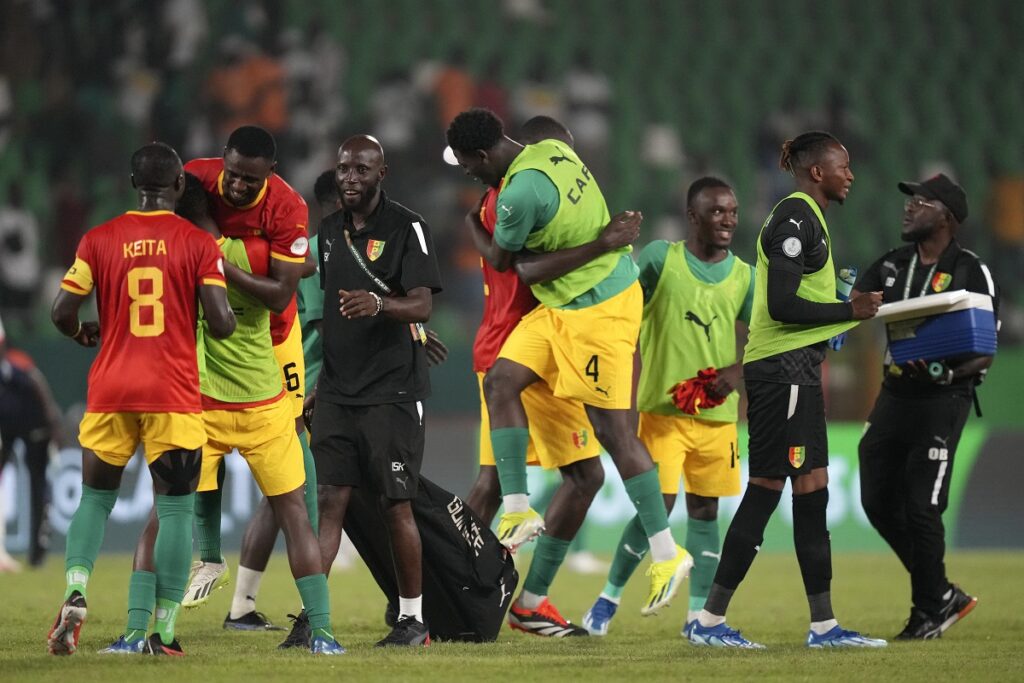Guinea's players celebrate at the end of the African Cup of Nations Group C soccer match between Guinea and Gambia, at the Charles Konan Banny stadium in Yamoussoukro, Ivory Coast, Friday, Jan. 19, 2024. (AP Photo/Sunday Alamba)