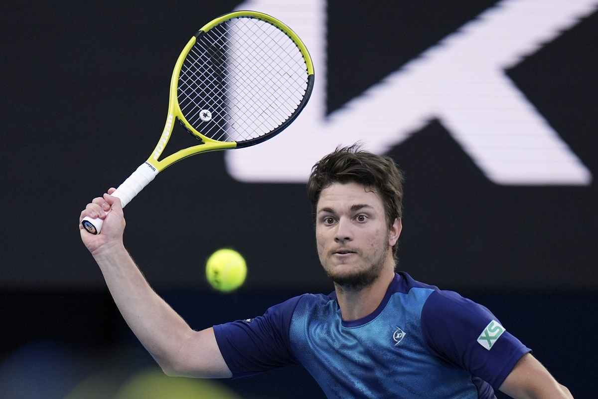 Miomir Kecmanovic of Serbia plays a forehand return to Carlos Alcaraz of Spain during their fourth round match at the Australian Open tennis championships at Melbourne Park, Melbourne, Australia, Monday, Jan. 22, 2024. (AP Photo/Andy Wong)