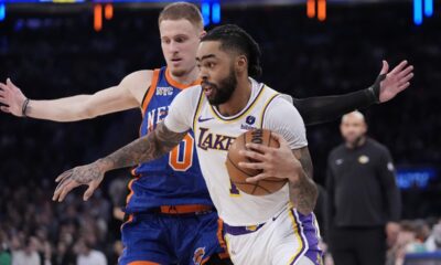 Los Angeles Lakers' D'Angelo Russell (1) drives past New York Knicks' Donte DiVincenzo (0) during the first half of an NBA basketball game Saturday, Feb. 3, 2024, in New York. (AP Photo/Frank Franklin II)