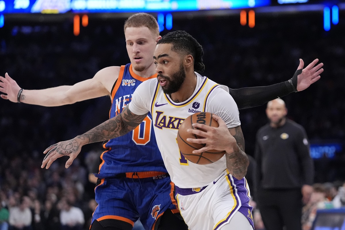 Los Angeles Lakers' D'Angelo Russell (1) drives past New York Knicks' Donte DiVincenzo (0) during the first half of an NBA basketball game Saturday, Feb. 3, 2024, in New York. (AP Photo/Frank Franklin II)