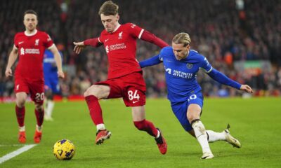 Liverpool's Conor Bradley, left, challenges for the ball with Chelsea's Mykhailo Mudryk during the English Premier League soccer match between Liverpool and Chelsea, at Anfield Stadium, Liverpool, England, Wednesday, Jan.31, 2024. (AP Photo/Jon Super)