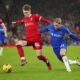 Liverpool's Conor Bradley, left, challenges for the ball with Chelsea's Mykhailo Mudryk during the English Premier League soccer match between Liverpool and Chelsea, at Anfield Stadium, Liverpool, England, Wednesday, Jan.31, 2024. (AP Photo/Jon Super)