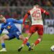 Leipzig's Xaver Schlager, left, and Bayern's Aleksandar Pavlovic challenge for the ball during the German Bundesliga soccer match between FC Bayern Munich and RB Leipzig at the Allianz Arena in Munich, Germany, Feb. 24, 2024. (AP Photo/Matthias Schrader)