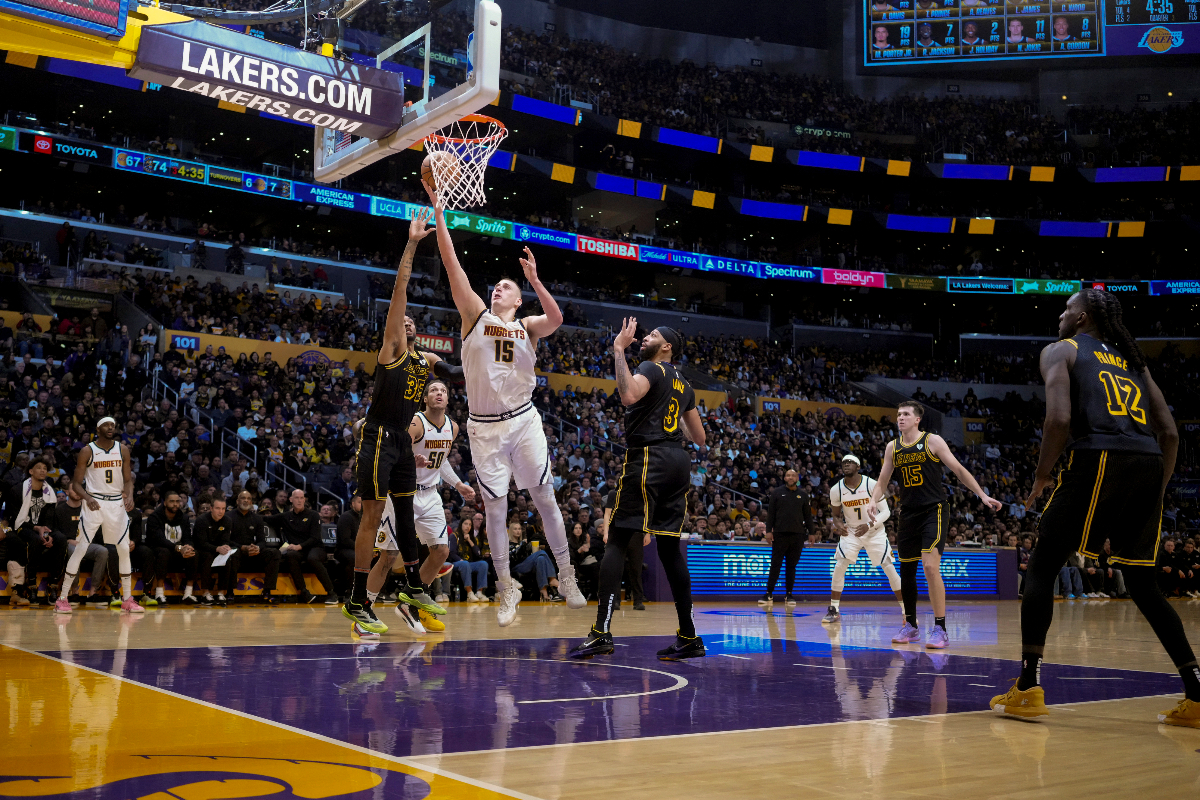 Denver Nuggets center Nikola Jokic (15) goes to the basket against Los Angeles Lakers forward Christian Wood (35) during the second half of an NBA basketball game in Los Angeles, Thursday, Feb. 8, 2024. (AP Photo/Eric Thayer)