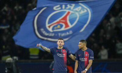 PSG's Kylian Mbappe, right, celebrates with PSG's Lucas Hernandez at the end of the Champions League round of 16 first leg soccer match between Paris Saint-Germain and Real Sociedad, at the Parc des Princes stadium in Paris, France, Wednesday, Feb. 14, 2024. (AP Photo/Christophe Ena)