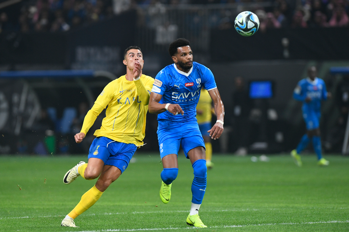 Al Nassr's Cristiano Ronaldo, left, fights for the ball with Al Hilal's Al Bulayhi during Riyadh Season Cup 2024 final match at Kingdom Arena Stadium in Riyadh, Saudi Arabia, Thursday, Feb. 8, 2024. (AP Photo)