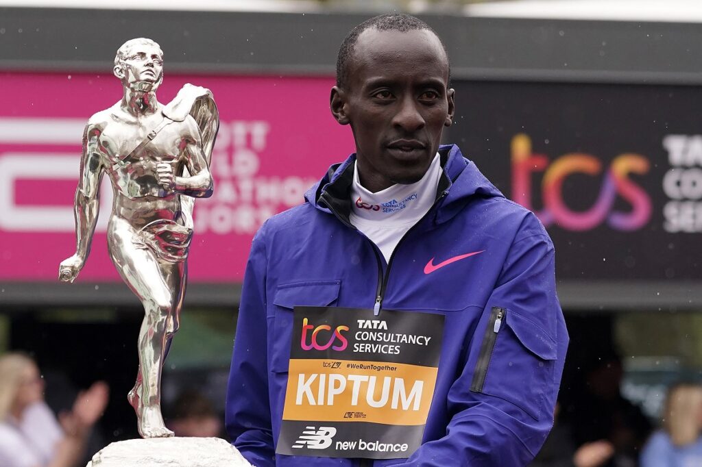 FILE - Men's race winner Kelvin Kiptum of Kenya holds a trophy together with women's race winner Sifan Hassan, unseen, of the Netherlands after the London Marathon in London on April 23, 2023. Kiptum was killed along with his coach in a car crash in Kenya late Sunday, Feb. 11, 2024. (AP Photo/Alberto Pezzali, File)