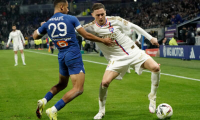 Lyon's Nemania Matic fights for the ball with Marseille's Iliman Ndiaye during a French League One soccer match between Lyon and Marseille at the Groupama stadium, outside Lyon, France, Sunday, Feb. 4, 2024. (AP Photo/Laurent Cipriani)