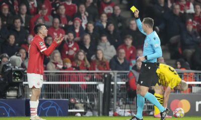 PSV's Hirving Lozano, left, is shown a yellow card by Serbian referee Srdjan Jovanovic during the Champions League round of 16 first leg soccer match between PSV Eindhoven and Borussia Dortmund at Philips stadium in Eindhoven, Netherlands, Tuesday, Feb. 20, 2024. (AP Photo/Peter Dejong)
