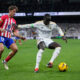 Atletico Madrid's Marcos Llorente, left, and Real Madrid's Ferland Mendy challenge for the ball during the Spanish La Liga soccer match between Real Madrid and Atletico Madrid at the Santiago Bernabeu stadium in Madrid, Spain, Sunday, Feb. 4, 2024. (AP Photo/Bernat Armangue)