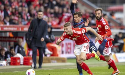 Heidenheim Nikola Dovedan, center right, vies for the ball with Berlin's Andras Schäfer, foreground and Lucas Tousart (right).l, during the Germany Bundesliga soccer match between Union Berlin and FC Heidenheim, in Berlin, Saturday, Feb. 24, 2024. (Andreas Gora/dpa via AP)