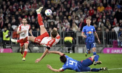 Bayern Munich's Harry Kane takes a back kick against Leipzig's Willi Orban during the Bundesliga soccer match between Bayern Munich and RB Leipzig, at the Allianz Arena in Munich, Germany, Saturday Feb. 24, 2024. (Sven Hoppe/dpa via AP)
