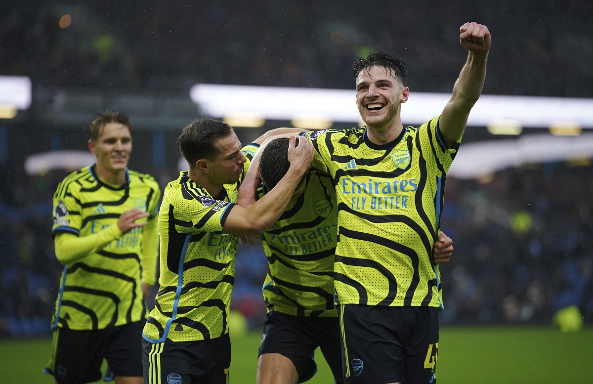 Arsenal's Kai Havertz, centre, celebrates with teammates Declan Rice, right and Cedric Soares after scoring their side's fifth goal of the game , during the English Premier League soccer match between Burnley and Arsenal, at Turf Moor, in Burnley, England, Saturday, Feb. 17, 2024. (Peter Byrne/PA via AP)