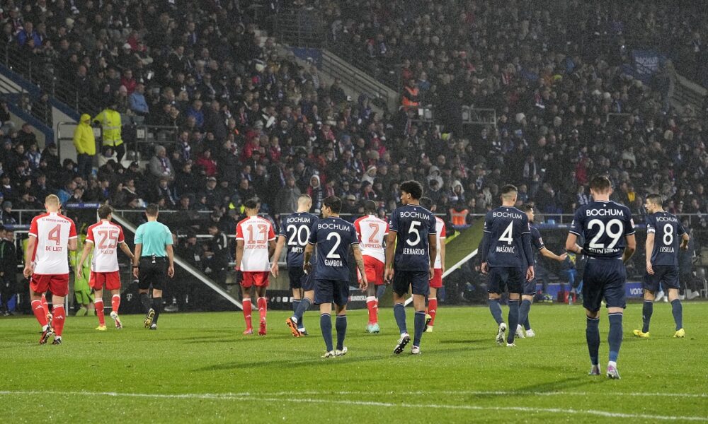 Both teams leave the pitch when the referee interrupted the match because of tennis balls on the pitch, thrown by fans as a protest against investors in the Bundesliga during the German Bundesliga soccer match between VfL Bochum and FC Bayern Munich in Bochum, Germany, Sunday, Feb. 18, 2024. (AP Photo/Martin Meissner)