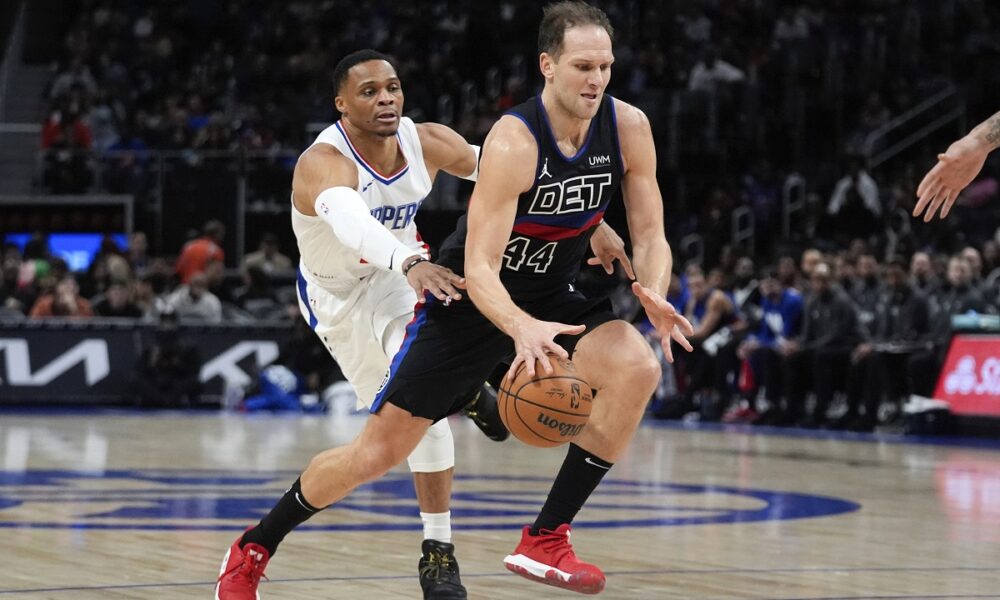 Detroit Pistons forward Bojan Bogdanovic (44) drives on Los Angeles Clippers guard Russell Westbrook (0) in the first half of an NBA basketball game in Detroit, Friday, Feb. 2, 2024. (AP Photo/Paul Sancya)