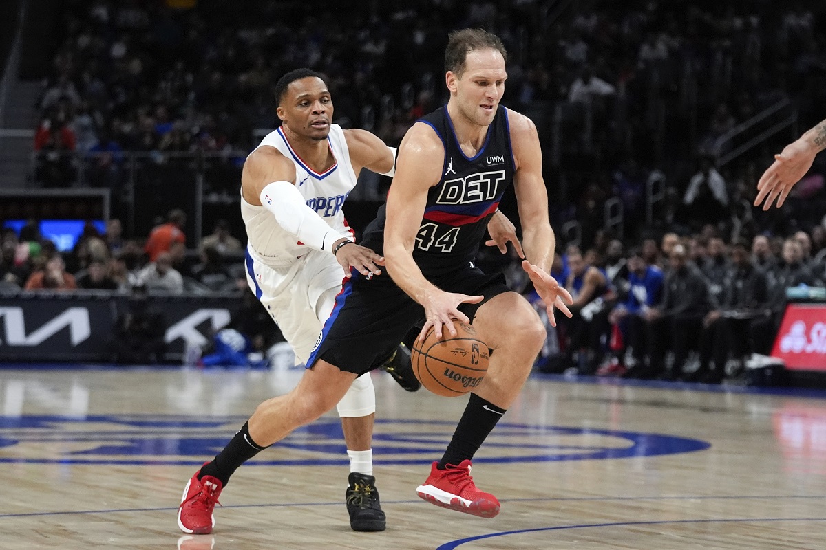 Detroit Pistons forward Bojan Bogdanovic (44) drives on Los Angeles Clippers guard Russell Westbrook (0) in the first half of an NBA basketball game in Detroit, Friday, Feb. 2, 2024. (AP Photo/Paul Sancya)