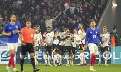 Germany players celebrate after Germany's Florian Wirtz scored his side's opening goal during an international friendly soccer match between France and Germany at the Groupama stadium in Decines, near Lyon, central France, Saturday, March 23, 2024. (AP Photo/Laurent Cipriani)