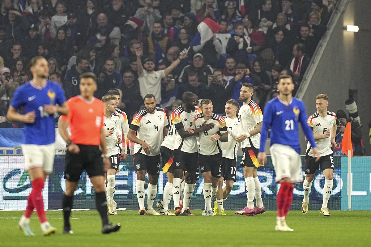 Germany players celebrate after Germany's Florian Wirtz scored his side's opening goal during an international friendly soccer match between France and Germany at the Groupama stadium in Decines, near Lyon, central France, Saturday, March 23, 2024. (AP Photo/Laurent Cipriani)
